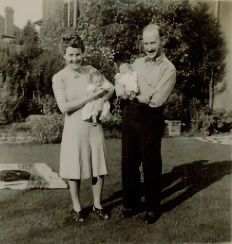 Vintage photo of the Wagner sisters. A 1945 family photograph of Jean and Leon Wagner with their newborn twins, Paula and Naomi, in London, illustrating the early family history in 'Longing to Belong – Newcomers in an Ancient Land.'